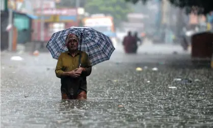  ?? Photograph: Arun Sankar/AFP/Getty Images ?? A man wades through a flooded street after heavy monsoon rains in Chennai, India, 8 November.