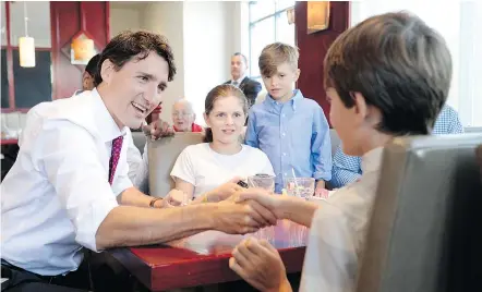  ?? — THE CANADIAN PRESS ?? Prime Minister Justin Trudeau, shown visiting a restaurant Wednesday in Gatineau, Que., has become personally involved in trying to fix problems with the federal payroll system.