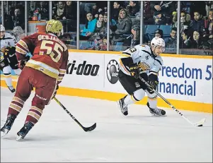  ?? JEREMY FRASER/CAPE BRETON POST ?? Giovanni Fiore, right, of the Cape Breton Screaming Eagles carries the puck into the attacking zone as Olivier Desjardins of the Acadie-Bathurst Titan gets ready to pressure during Quebec Major Junior Hockey League action at Centre 200 on Friday. The...