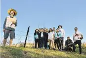  ?? JEFF GRITCHEN ORANGE COUNTY REGISTER ?? Joel Robinson, founder of Naturalist For You, with residents who oppose the Orange Heights plan.