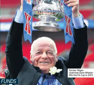  ??  ?? Former Wigan chairman Dave Whelan lifts the FA Cup in 2013