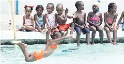  ?? FILE ?? Scores of children learn to swim at the National Stadium swimming pool, which has not been certified by the Ministry of Health.