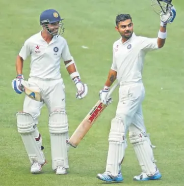  ?? GETTY ?? ■ Ajinkya Rahane (left) and Virat Kohli added 262 at MCG in 2014 and they’ll look to repeat the heroics this time in the Adelaide Test.