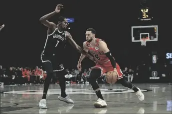  ?? AP PHOTO/JESSIE ALCHEH ?? Chicago Bulls guard Zach LaVine (8) drives against Brooklyn Nets forward Kevin Durant (7) during the first half of an NBA basketball game on Tuesday in New York.