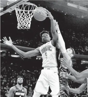  ?? SARAH STIER/GETTY ?? Magic rookie Mohamed Bamba, left, is learning to be more of a force in the paint.