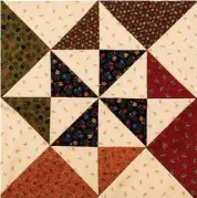  ??  ?? If you’re looking for a fun quilt but the bright fabrics aren’t your cup of tea, try a color palette of subtle traditiona­l colors. Either way, it’s fun to see the pinwheels come together.