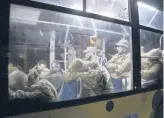  ?? AP ?? Ukrainian soldiers who left a steel plant under attack in Mariupol sit in a bus Friday near a penal colony in Olyonivka, Ukraine.