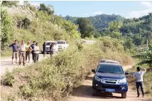  ??  ?? A group claiming to be local villagers use vehicles to block the roads leading to a mineshaft near Danaoshan in southern China’s Yunnan province. (AP)