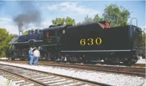  ?? STAFF FILE PHOTO BY DOUG STRICKLAND ?? People look at the Southern 630 engine at the Tennessee Valley Railroad Museum at a previous Railfest.