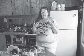  ?? STAFF PHOTO BY DOUG STRICKLAND ?? Kaylynn Sanchez-Miguel stands in the kitchen of the trailer she shares with her husband, David, in the Blue Ridge Estates trailer park Wednesday.