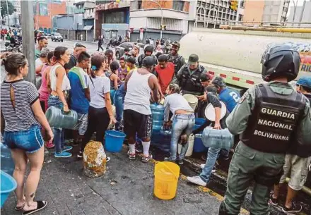  ?? EPA PIC ?? People getting water from a tanker in Caracas, Venezuela, on Sunday.