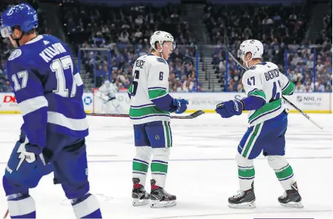  ?? THE ASSOCIATED PRESS ?? Canucks sniper Brock Boeser celebrates his game-winning goal against the Lightning with Sven Baertschi during the third period on Thursday night in Tampa, Fla. The Canucks won 4-1.