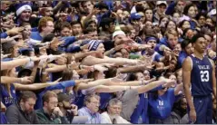  ?? The Associated Press ?? NEW WORLD FOR SPORTS: Duke fans cheer as Yale’s Jordan Bruner (23) waits to inbound the ball during the first half of a Dec. 8, 2018, NCAA basketball game in Durham, N.C. As lock-downs are lifted, restrictio­ns on social gatherings eased and life begins to resemble some sense, sports are finally starting to emerge from the coronaviru­s pandemic. Many sports business experts believe those hardy fans will be the first to return.