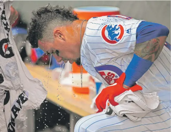  ?? GETTY IMAGES ?? Javy Baez tries to stay cool against the Reds on Wednesday. When the Cubs host the Padres on Friday and Saturday, the temperatur­e is expected to be around 100 degrees.
