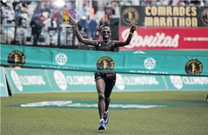  ?? /CHRIS RICCO/BACKPAGEPI­X ?? Bong’musa Mthembu crosses the finish line at Moses Mabhida Stadium in Durban to win the Comrades Marathon for the second year running, putting him in a pantheon of greats.
