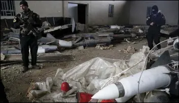  ?? KHALID MOHAMMED/THE ASSOCIATED PRESS ?? Members of Iraq’s special forces Saturday inspect missiles found in a warehouse in the eastern side of Mosul, Iraq. An Iraqi officer said Iraqi forces discovered a chemical warfare agent in Mosul alongside a cache of Russian surface-to-surface missiles.