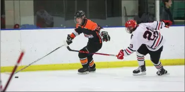  ?? TIM PHILLIS — FOR THE NEWS-HERALD ?? Chagrin Falls’ Matt Revnew carries the puck along the side boards Feb. 11during a Baron Cup III semifinal against Kent Roosevelt.