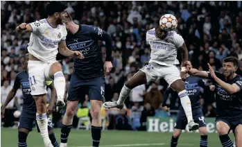  ?? | SERGIO PEREZ EPA ?? RODRYGO rises high to head in the equaliser for Real Madrid against Manchester City on Wednesday.