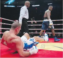  ?? JACQUES BOISSINOT/THE CANADIAN PRESS ?? Eleider Alvarez, right, looks back at Lucian Bute after knocking him down Friday in Quebec City.