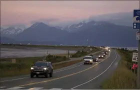  ?? SARAH KNAPP — HOMER NEWS VIA AP ?? A line of cars evacuates the Homer Spit in Homer, Alaska, on July 28, after a tsunami warning was issued following a magnitude 8.2earthquak­e. The tsunami warning for much of Alaska’s southern coast was canceled when the biggest wave, of just over a half foot, was recorded in Old Harbor.
