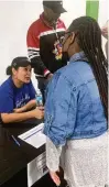  ?? ?? A representa­tive from Lumpia Queen speaks with a youth at the Meet the Employers event