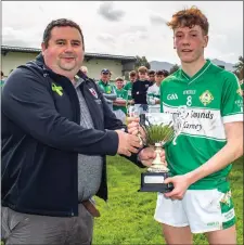  ??  ?? Seán O Keeffe from East Region Coiste na nÓg presented Legion captain Ethan O Neill with the Division 1 Cup