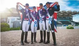  ??  ?? The British dressage team celebrate their bronze medal