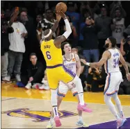  ?? MARK J. TERRILL — THE ASSOCIATED PRESS ?? Los Angeles Lakers forward Lebron James, left, scores to pass Kareem Abdul-jabbar to become the NBA’S all-time leading scorer as Oklahoma City Thunder guard Josh Giddey, center, and forward Kenrich Williams defend during the second half of an NBA basketball game Tuesday, Feb. 7, 2023, in Los Angeles.