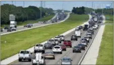  ?? MIKE LANG /SARASOTA HERALD-TRIBUNE VIA AP ?? Northbound traffic, right, on I-75 through Sarasota, Fla., is heavier than normal, but still moving on Thursday. Many South Florida residents are evacuating and heading north as Hurricane Irma approaches.