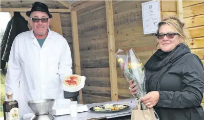  ?? ?? Sian Thompson with John McMillan at his artisan cheese stand at Achonry farmers’ market on Saturday. MORE PHOTOS ON PAGE 23