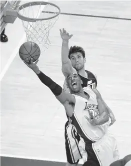  ?? MARK J. TERRILL AP ?? The Lakers’ Kobe Bryant goes up for a reverse layup past Jazz center Jeff Withey in the final game of his NBA career on Wednesday, April 13, 2016, in Los Angeles.