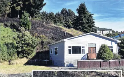  ?? PHOTOS: PETER MCINTOSH ?? A vegetation fire in Kaikorai Valley Rd early yesterday came perilously close to at least one house. Right: Fire investigat­or Mike Cahill looks for clues.