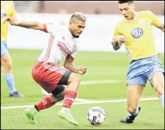  ??  ?? In the second half, Atlanta United switched to their away jerseys. Above: Forward Josef Martinez dribbles past a Chattanoog­a defender.