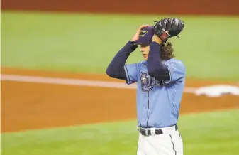  ?? Ronald Martinez / Getty Images ?? Rays starting pitcher Tyler Glasnow reacts after walking the Dodgers’ Max Muncy during the first inning. Glasnow allowed two runs in the inning and has a postseason ERA of 6.28.