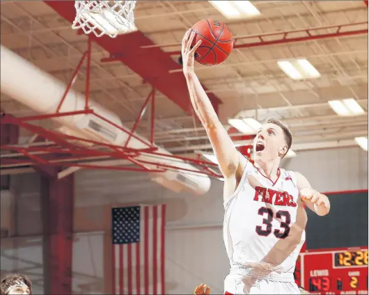  ?? STEVE WOLTMANN/LEWIS ?? Lyons graduate Connor Niego drives to the basket for Lewis during a game this season.