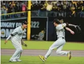  ?? JAE C. HONG/AP ?? Infielder Manny Machado, left, and reliever Josh Hader celebrate after the Padres’ 5-3 series-clinching win over the Dodgers in the NLDS on Saturday night.