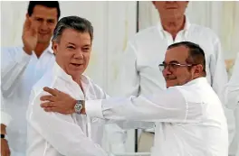  ?? PHOTO: REUTERS ?? Colombian President Juan Manuel Santos, left, and Marxist rebel leader Rodrigo Londono better known by the nom de guerre Timochenko, shake hands after signing an accord ending a half-century war that killed a quarter of a million people in Colombia.