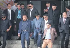  ?? APICHART JINAKUL ?? Leaders of the United Front for Democracy against Dictatorsh­ip leave the Criminal Court yesterday after being acquitted of terrorism charges.