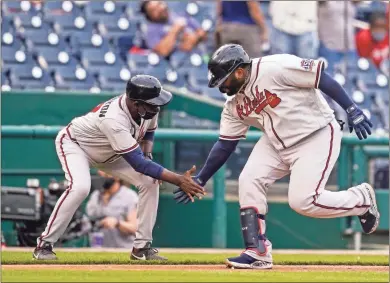  ?? Ap-alex Brandon ?? Braves’ Pablo Sandoval, right, celebrates his two-run home run with third base coach Ron Washington during the seventh inning of the second baseball game of a doublehead­er against the Nationals at Nationals Park, Wednesday. The Braves won the second game 2-0.