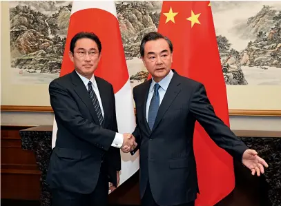  ??  ?? Chinese Foreign Minister Wang Yi (right) holds talks with his Japanese counterpar­t Fumio Kishida in Beijing on April 30, 2016.