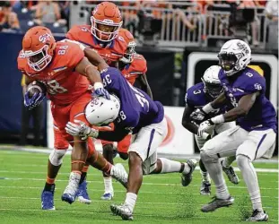  ?? Jerry Baker ?? Sam Houston State senior tight end Ragan Henderson, left, strongarms Stephen F. Austin defender Trenton Gordon after catching a pass in the second quarter of Saturday’s Southland Conference showdown at NRG Stadium.