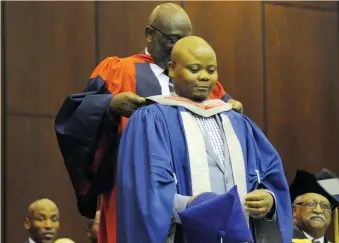  ?? PICTURE: ARMAND HOUGH/AFRICAN NEWS AGENCY (ANA) ?? PROUD MOMENT: Professor Loyiso Nongxa, former vice-chancellor of Wits, with Phindile Ntliziywan­a. Ntliziywan­a is only the second person from Matatiele in the Eastern Cape to graduate with a PhD. Nongxa was the first.