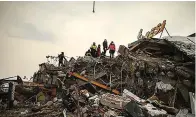  ?? (AP Photo/Emrah Gurel) ?? Rescue workers search for survivors on a collapsed building in Malatya, Turkey, Tuesday, Feb. 7, 2023. Search teams and aid are pouring into Turkey and Syria as rescuers working in freezing temperatur­es dig through the remains of buildings flattened by a magnitude 7.8 earthquake.