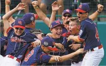  ?? Gene J. Puskar / Associated Press ?? Endwell, N.Y., pitcher Ryan Harlost (center) is in the middle of the dogpile celebratio­n.