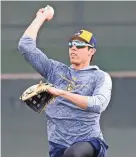  ??  ?? Brewers right fielder Christian Yelich throws during a spring training workout Saturday in Phoenix. JOE CAMPOREALE/USA TODAY SPORTS