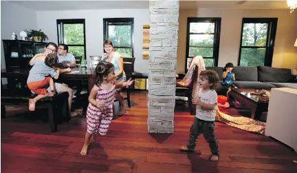  ?? PHOTOS: CHRISTINNE MUSCHI ?? Co-owning couples, from left, Alexandra Boisclair and Samuel Desrochers-Denault, (not in photo), Loïc Bisière and Jessica Dupont watch their children frolic in their new home. The couples plan to assess the co-living experiment after one year.