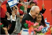  ?? AP FILE PHOTO ?? Then-Israeli president Shimon Peres hugs children during a welcoming ceremony held by President Xi Jinping at the Great Hall of the People in Beijing on April 8, 2014.