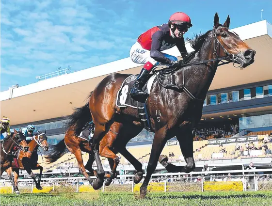  ?? Picture: AAP IMAGE/ALBERT PEREZ ?? Jockey Scott Galloway rides Malahide to victory in the QTIS Two-Year-Old Fillies Plate at Doomben during the winter carnival.