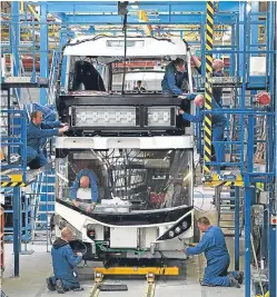  ?? Picture: PA. ?? Alexander Dennis technician­s work on a new bus build.