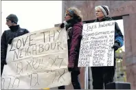  ?? CP PHOTO ?? The names of the victims of the shooting at the Tree of Life Synagogue in Pittsburgh are held during a vigil against anti-Semitism and white supremacy at the Human Rights Monument in Ottawa on Sunday.